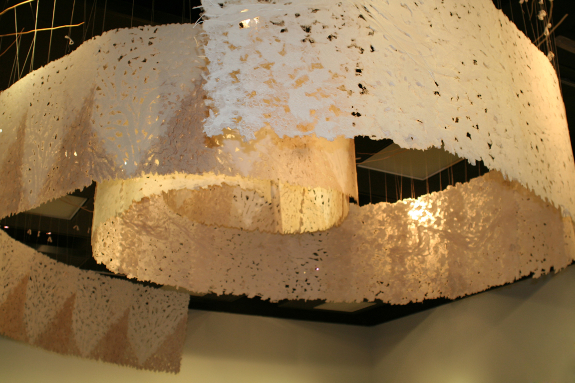 large handmade paper installation suspended from ceiling